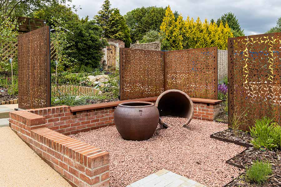 Brick retaining walls give this sloping garden at Oxford Garden Centre structure and defines the various areas of this beautiful garden
